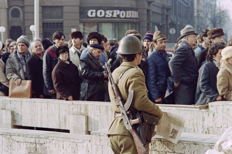 People wait to pay tribute to the victims after the city's massacre in the streets of Timisoara, on December 31, 1989, as the anti-Communist uprising to end Nicolae Ceausescu's 24 years of dictatorial rule continue. The communist dictator Nicolae Ceausescu and his wife Elena were deposed and executed by a firing squad on December 25, 1989.,Image: 489567464, License: Rights-managed, Restrictions: , Model Release: no